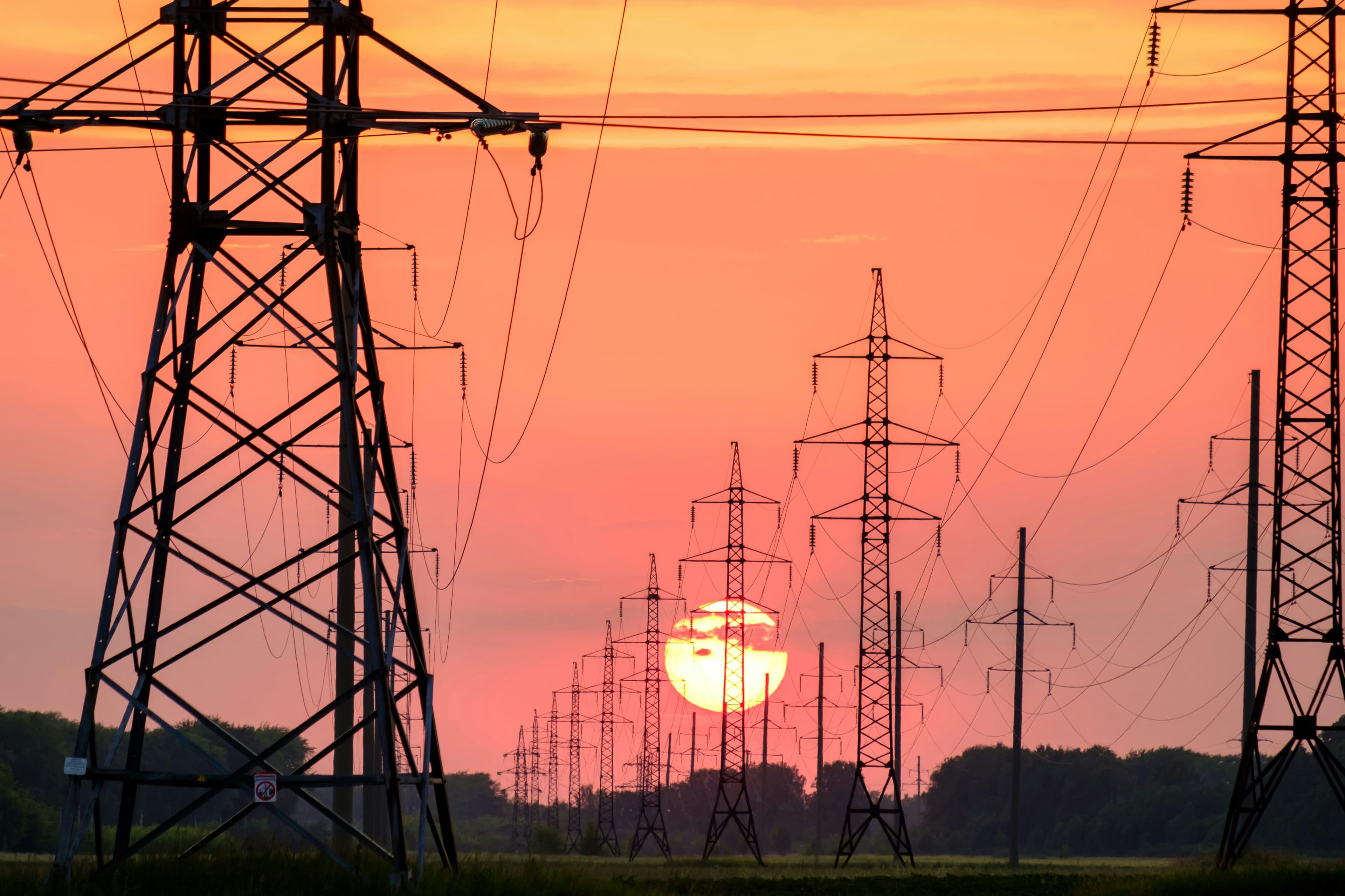 Electricity transmission towers at sunset