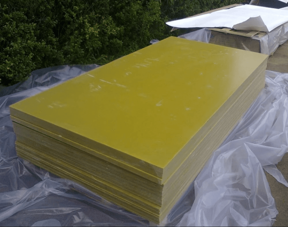 Stacked flat FRP laminate sheets ready for dispatch
